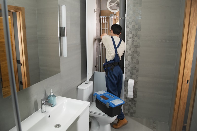 Plumber installing a water filtration unit during professional equipment installation