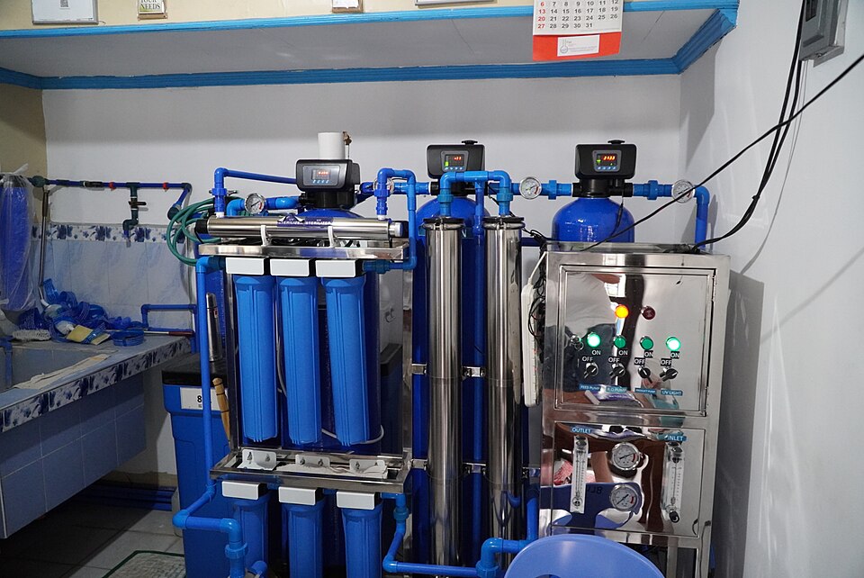 Stainless steel UV sterilizer unit installed on a commercial water treatment system
